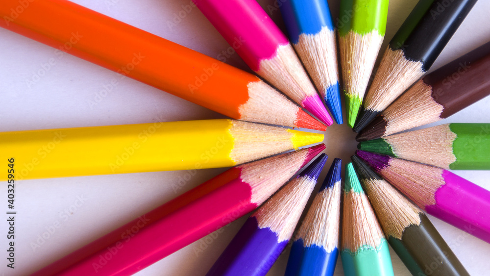 Colored pencils placed in circles on a white background. Colored pencils placed in circles on a white background.