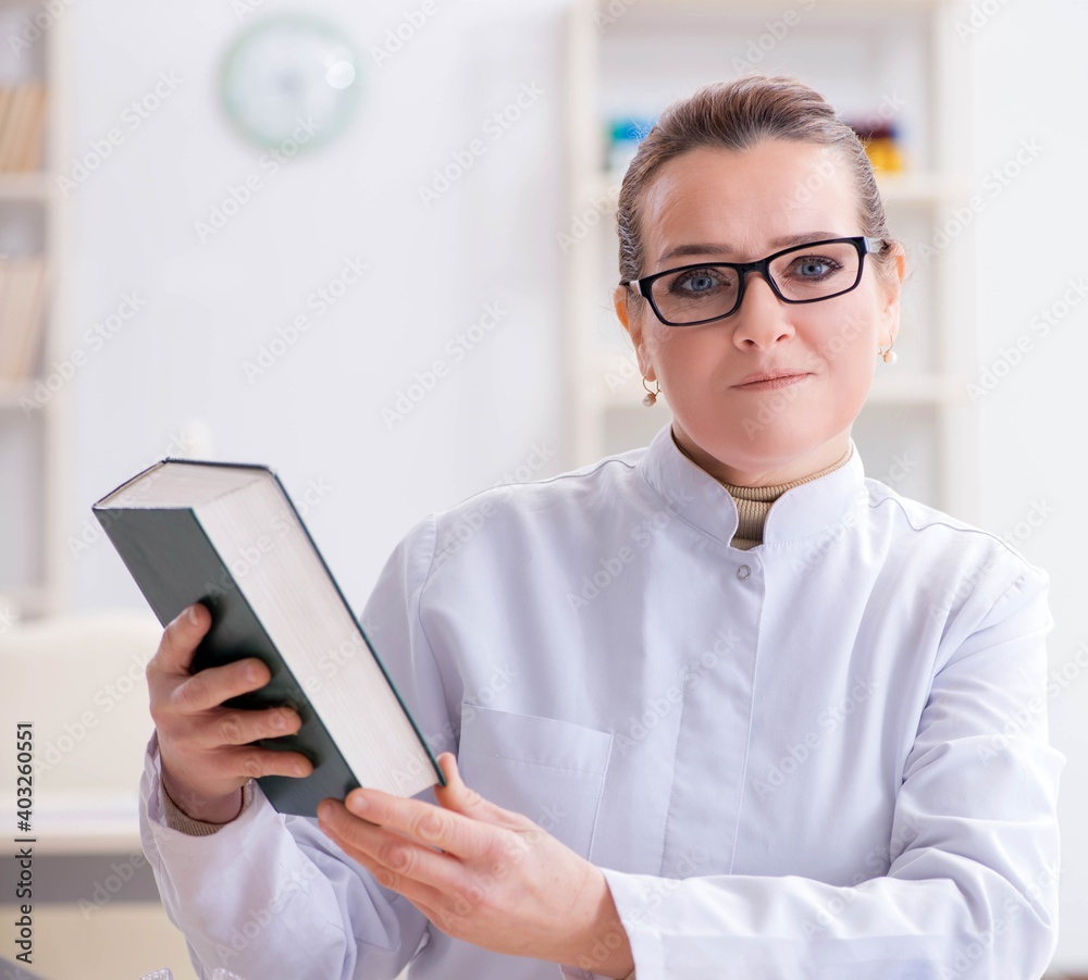 Woman doctor studying human skeleton Woman doctor studying human skeleton