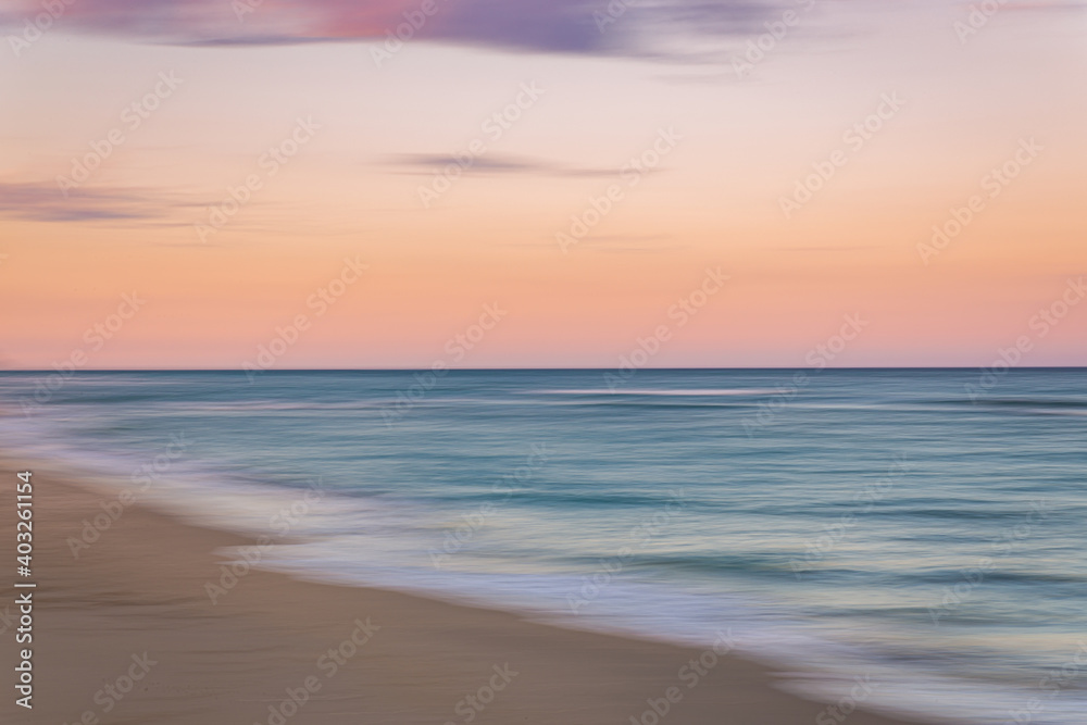 Palm Beach Island beach sunset with slow shutter pan of pink, blue and purple skies with green ocean water Palm Beach Island beach sunset with slow shutter pan of pink, blue and purple skies with green ocean water
