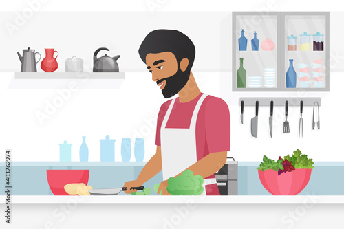 Man cooking food vector illustration. Cartoon young happy bearded male chef character in apron cooks vegetarian meal, cutting vegetables with knife in kitchen home room interior, culinary background