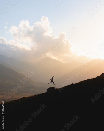 Silhouette of a man jumping at sunset in the mountains  © Francesco