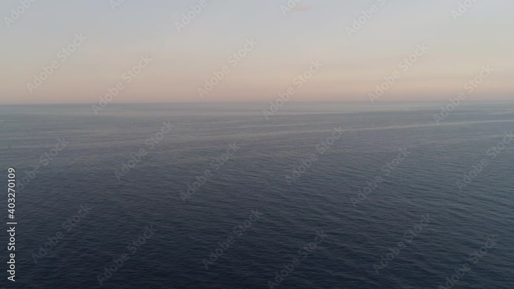 aerial view boundless water surface sea. Flying over surface sea at sunset. aerial seascape ocean surface. Travel concept
