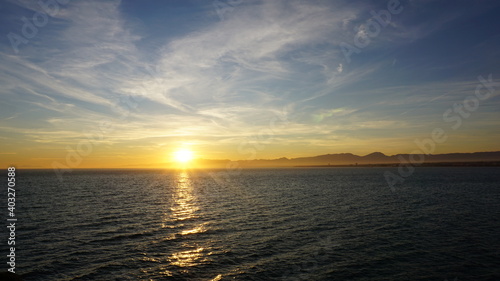 sunset over the mountains near the sea