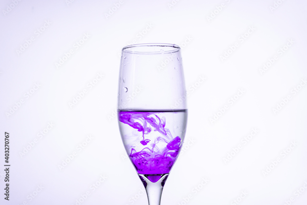 Purple ink in a glass of water