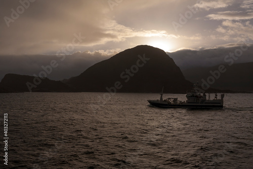 Modern fishing vessel approaching the harbour at Ålesund, Møre og Romsdal, Norway at dawn
