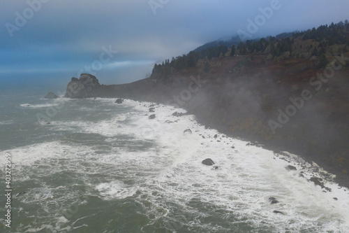 The marine layer drifts over the amazing coastline of Northern California in Klamath. This incredible region is home to the world's most beautiful temperate forests. Redwood trees are common here.