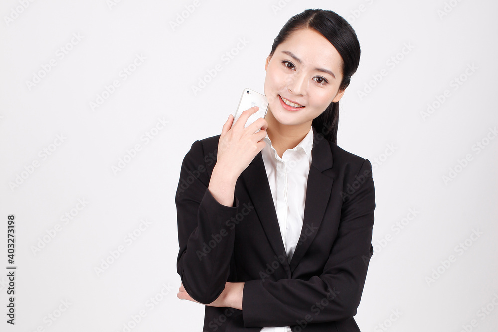 A young business woman holding a telephone A young business woman holding a telephone