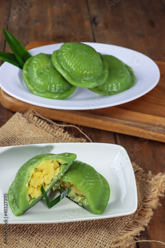 Kue ku or kue thok or ang ku kueh or chinese red tortoise cake is a traditional Asian cake made from glutinous rice flour sfuffed with green bean. The Chinese word on the cake is mean blessing. photo