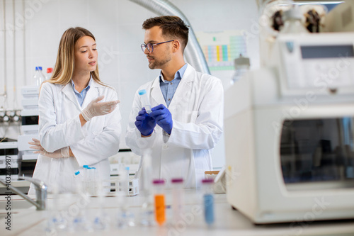 Group of young researchers analyzing chemical data in the laboratory