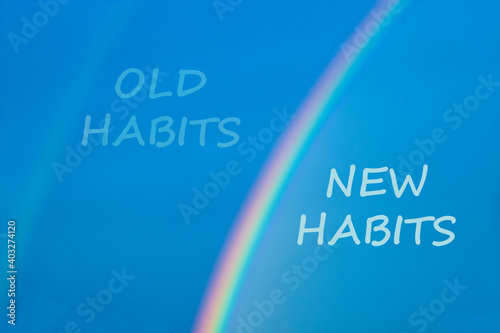 Old or new habits symbol. Rainbow in the blue sky. Words 'old habits, new habits'. Peaceful nature. Copy space. Business and old or new habits concept.