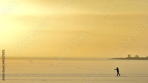 Skiing man on the ice of the lake