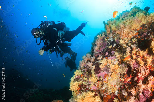 Female SCUBA diver on a tropical coral reef in the Andaman Sea, Asia