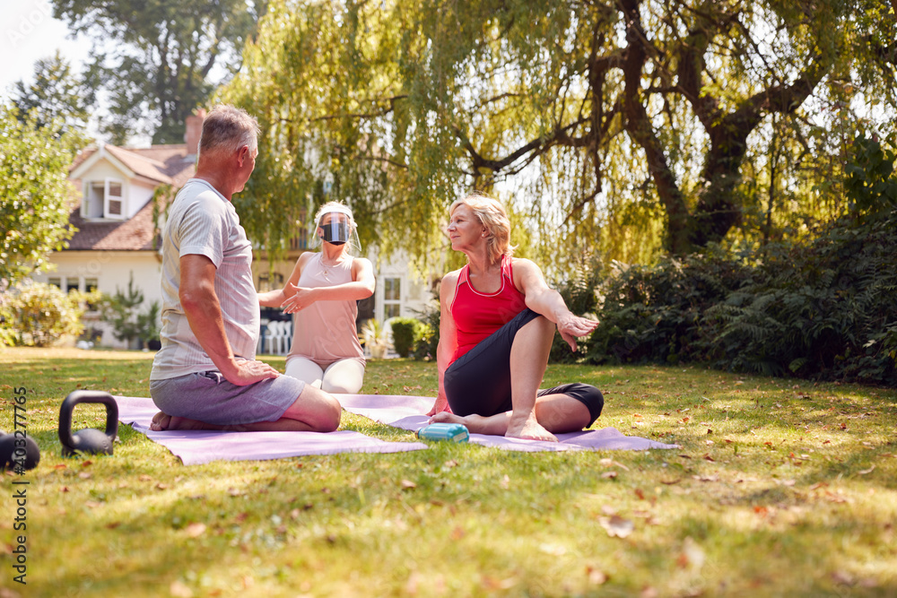 Senior Couple Taking Part In Private Socially Distanced Yoga Class With Teacher At Home Senior Couple Taking Part In Private Socially Distanced Yoga Class With Teacher At Home