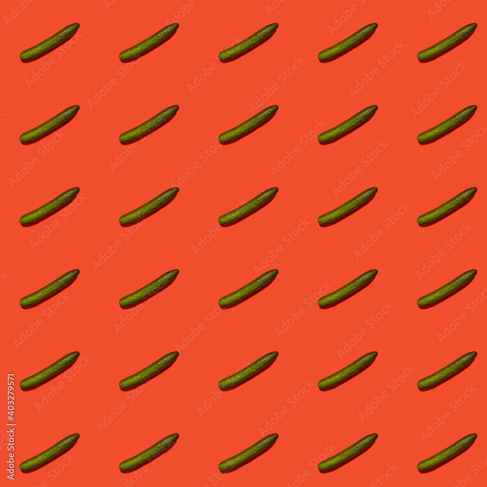 Colorful pattern of green cucumbers on a red background. Pattern. Colorful pattern of green cucumbers on a red background. Pattern.