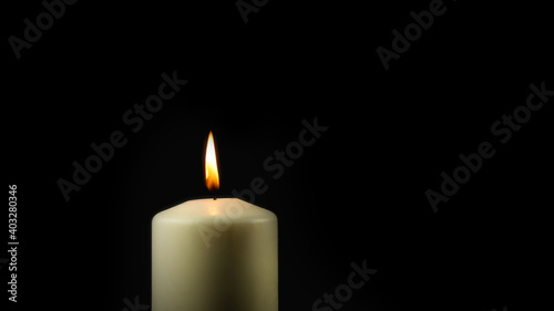 burning candle in the dark