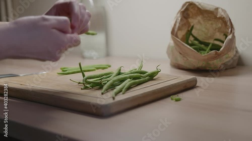 A woman remove the stems green beans