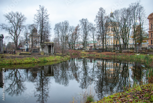 An autumn view on the Monastery Island with churches at the back and an old cemetery reflecting in the pond, Saint Petersburg, Russia © Nigar