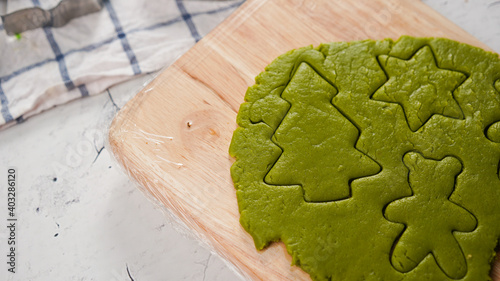 Green ginger bread cookies homemade cooking for Christmas traditional dessert. Kids and family love to prepare green tea cookies. Celebration cookies for Christmas.