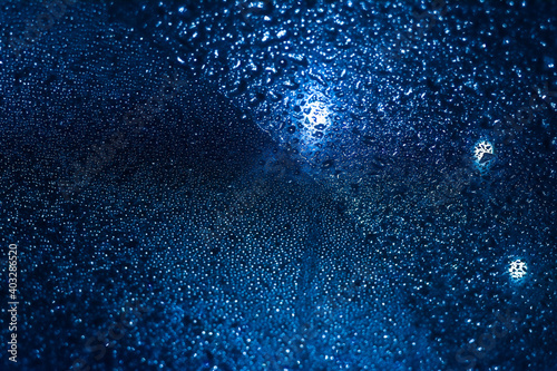 Closeup Rain Drops On Blue background Glass. High quality photo