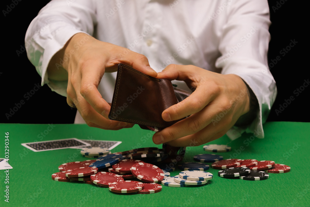 Devastated gambler man losing a lot of money playing poker in casino, gambling addiction. Divorce, loss, ruin, debt, ludopata concept Devastated gambler man losing a lot of money playing poker in casino, gambling addiction. Divorce, loss, ruin, debt, ludopata concept
