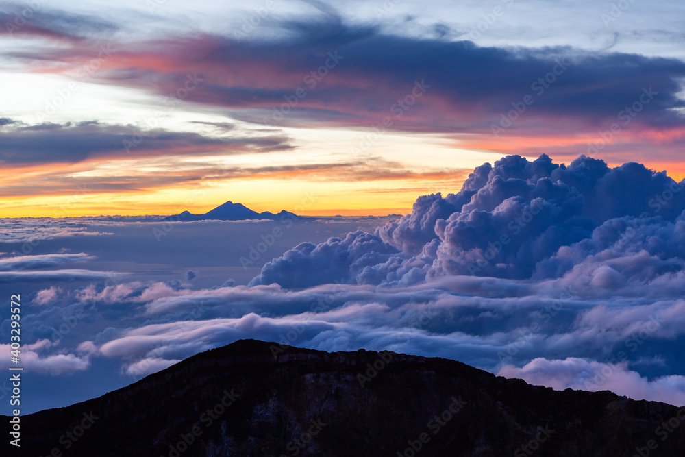Amazing cloudscape with mt. Rinjani at horizon. View from mt. Agung at sunrise. Bali, Indonesia.