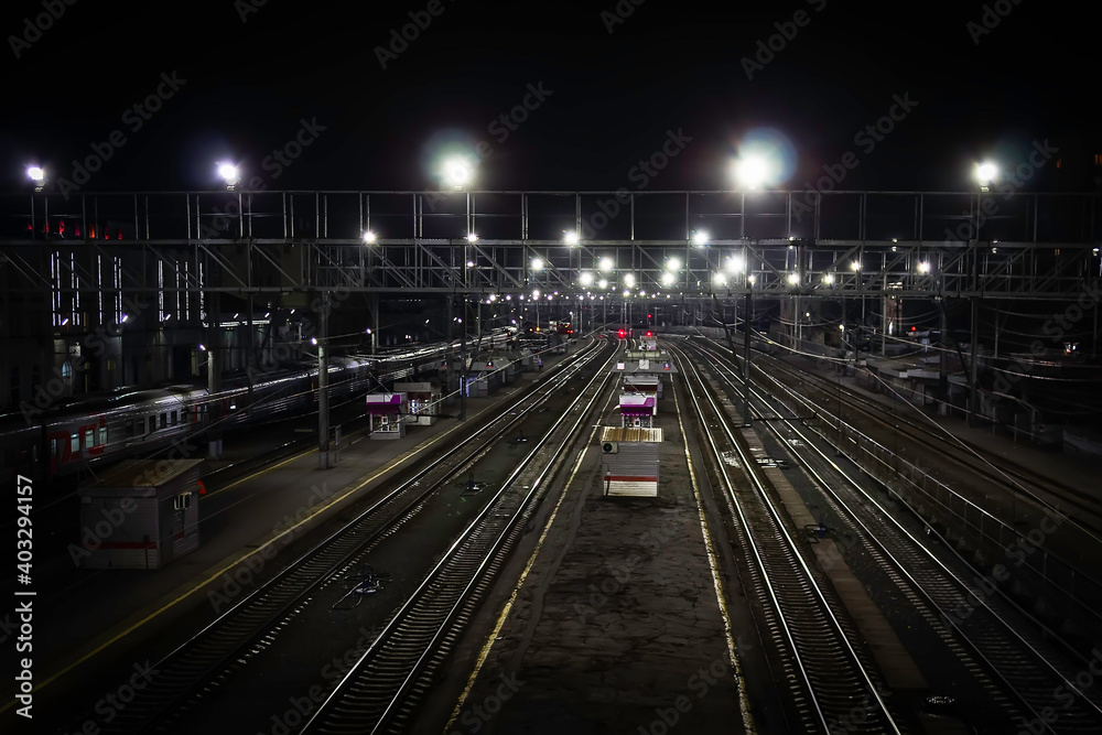 Large train station at night. Passenger trains at the railway station at night, a little overhead view.