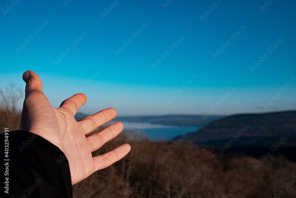 Hand pointing to the sky. Beautiful mountain landscape. Hand pointing to the sky. Beautiful mountain landscape.