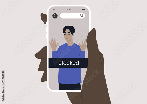 Hand holding a smartphone with a blocked user account, displayed on a screen, privacy in social media