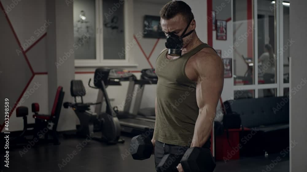 Fit young guy in gym with protective mask Fit young guy in gym with protective mask