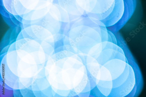 Blue light blur. Abstract Festive glitter Bokeh background. Soft yellow christmas backdrop.