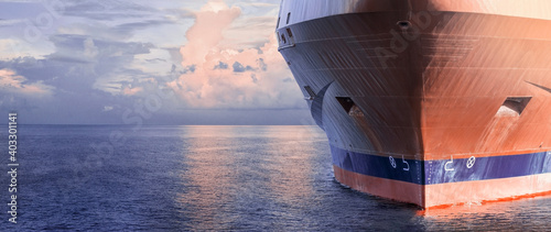 Close up of large merchant cargo ship in the middle of the ocean underway. Performing cargo export and import operations. © Denys Yelmanov 