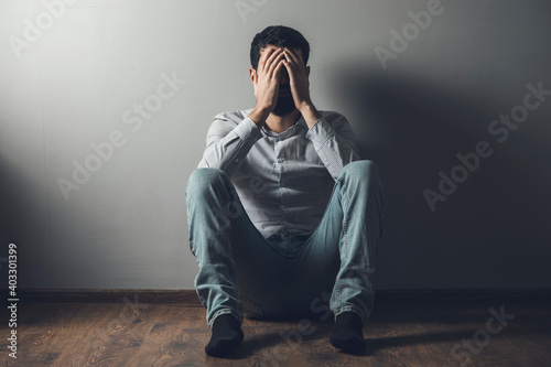 young sad man hand in head