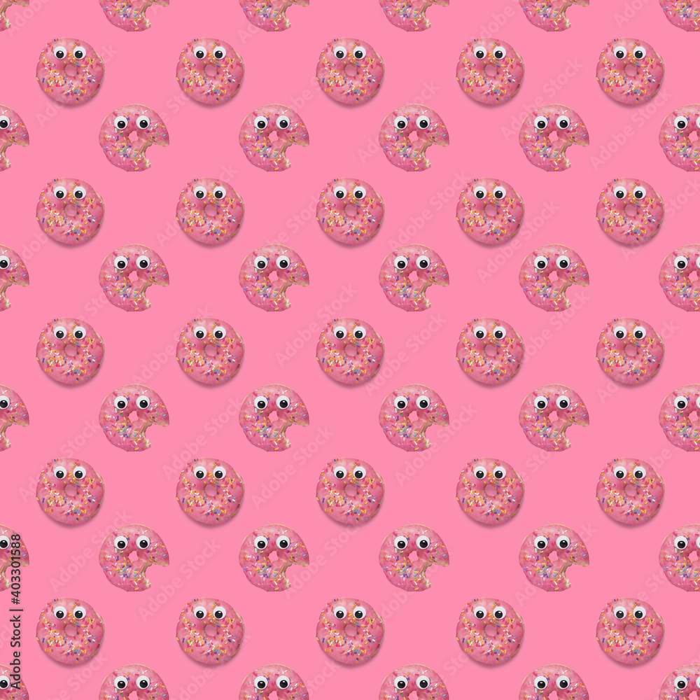 Seamless repeating pattern of pink dougnuts donuts with sprinkles and googly eyes on a pink background. Seamless repeating pattern of pink dougnuts donuts with sprinkles and googly eyes on a pink background.