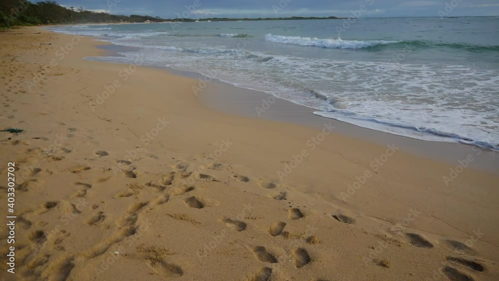 Footprints in the sand of a North Shore beach on Oahu Hawaii in the summer early morning before anyone is around. Footprints in the sand of a North Shore beach on Oahu Hawaii in the summer early morning before anyone is around.