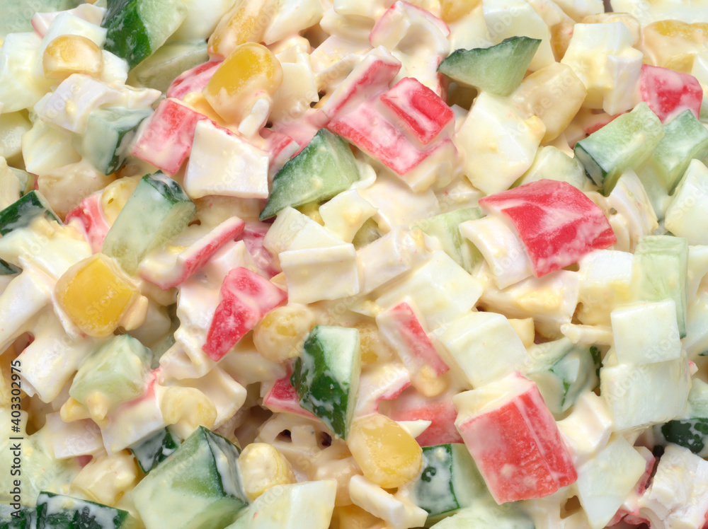 Background of salad of corn, crab sticks, cucumbers, eggs and mayonnaise Background of salad of corn, crab sticks, cucumbers, eggs and mayonnaise