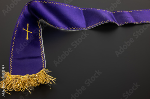 Purple violet priest's stole on a black background