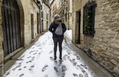 Woman jumping in snow