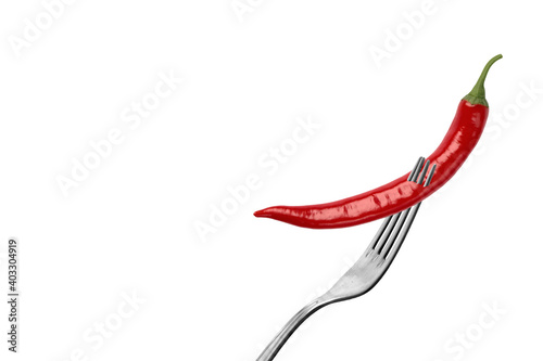 Isolated chili pepper on a white background. Impaled on a fork. Red, hot. Capsicum. Seasoning. Spice. Mexican. Element for the design.