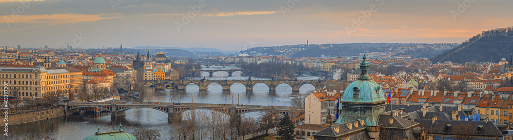 Beautiful spring sunset over the old city of Prague with wide angle view of the bridges over the Vltava river