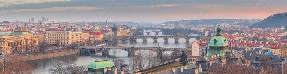 Beautiful spring sunset over the old city of Prague with wide angle view of the bridges over the Vltava river
