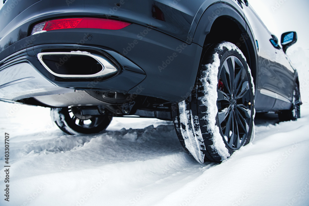 Car with winter tires on light-alloy wheels on the snow