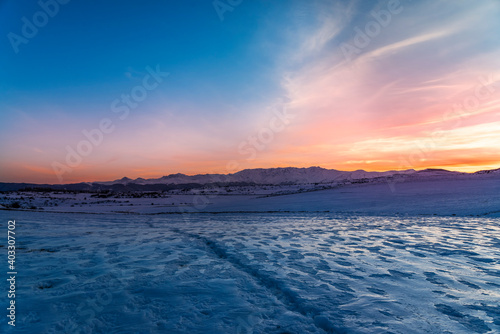 Beautiful panoramic sunset over the mountains and  snow-covered hills. Beautiful panoramic sunset over the mountains and  snow-covered hills. 