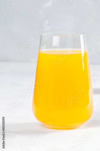 Orange juice in glass on white background. Helthy food and drink. Vegan diet. Fresh juice