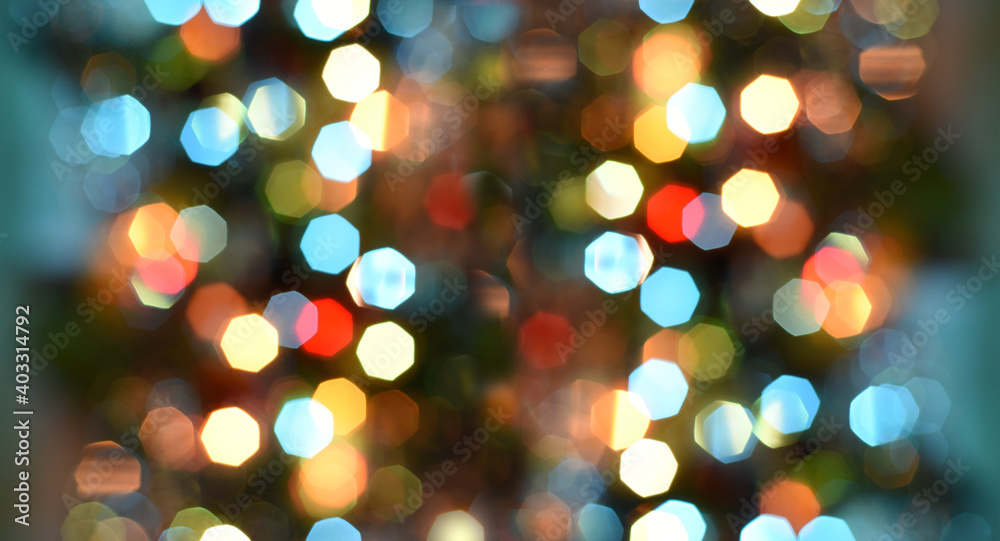 Beautiful bright bokeh from a garland of lanterns of different colors. Festive mood. Banner.