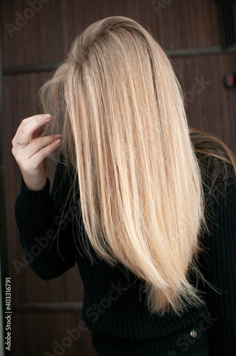 Back view of blonde hair with highlights on young woman