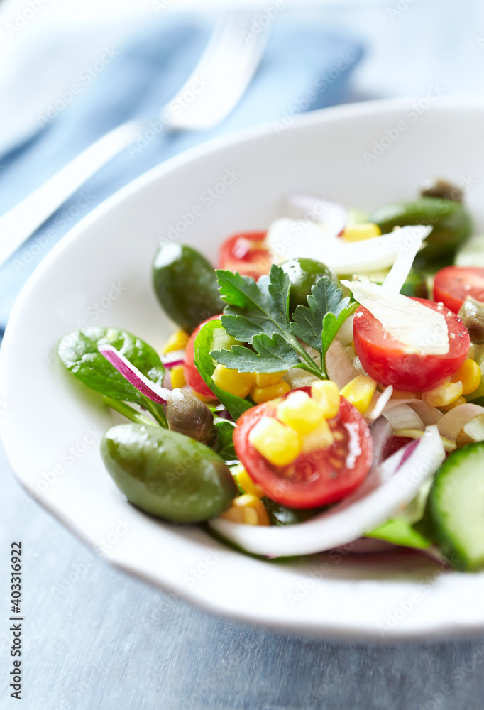 Healthy Salad with Green Olives, Baby Spinach, Cucumber, Cherry Tomatoes and Capers. Bright wooden background. Healthy Salad with Green Olives, Baby Spinach, Cucumber, Cherry Tomatoes and Capers. Bright wooden background.