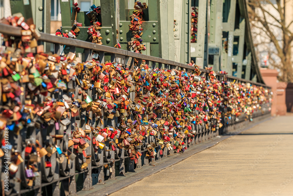 custom made wallpaper toronto digitalMany locks on the green bridge railing of the iron bridge in Frankfurt over the river Main. Locks of love in different colors in the sunshine
