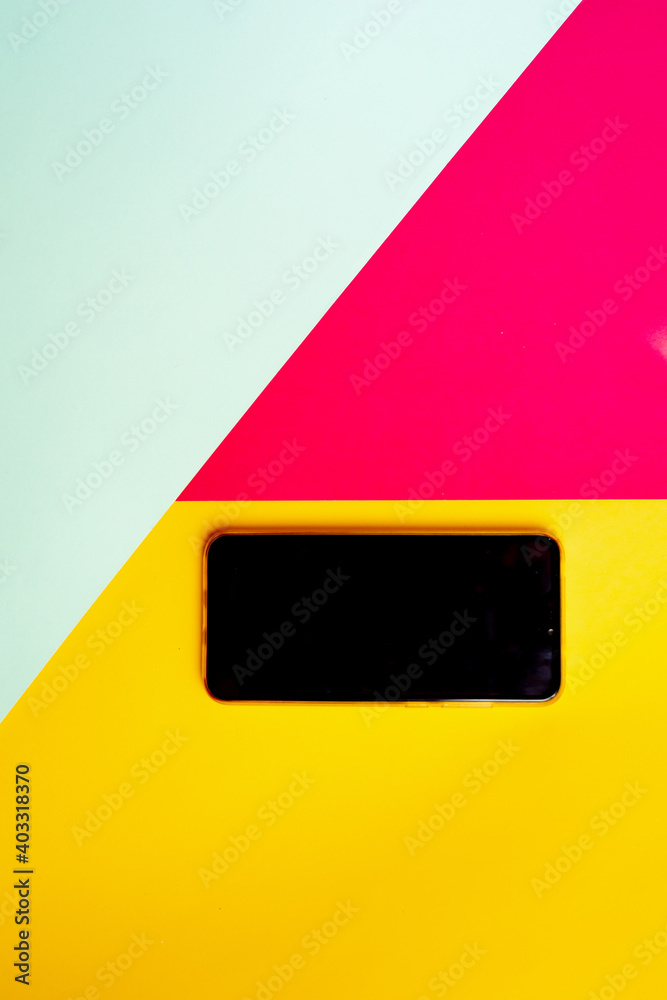 Empty phone isolated on pink yellow and blue background with copy space. - obrazy, fototapety, plakaty 