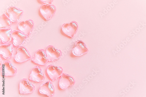 St. Valentine's Day concept. Many pink hearts isolated on pink pastel background. Postcard banner on valentines day. Love date lovesick wedding romance symbol. Top view flat lay, copy space