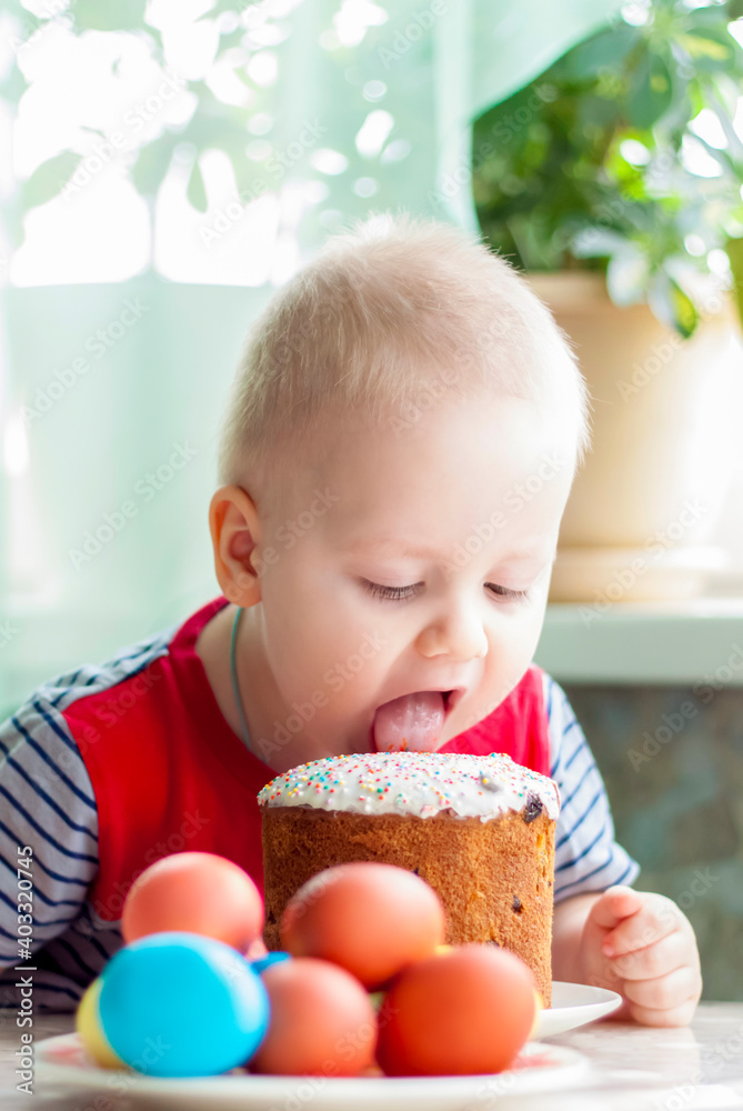 Portrait of a cute child with Easter eggs. Easter lunch. The feast of Holy Easter. Portrait of a cute child with Easter eggs. Easter lunch. The feast of Holy Easter.